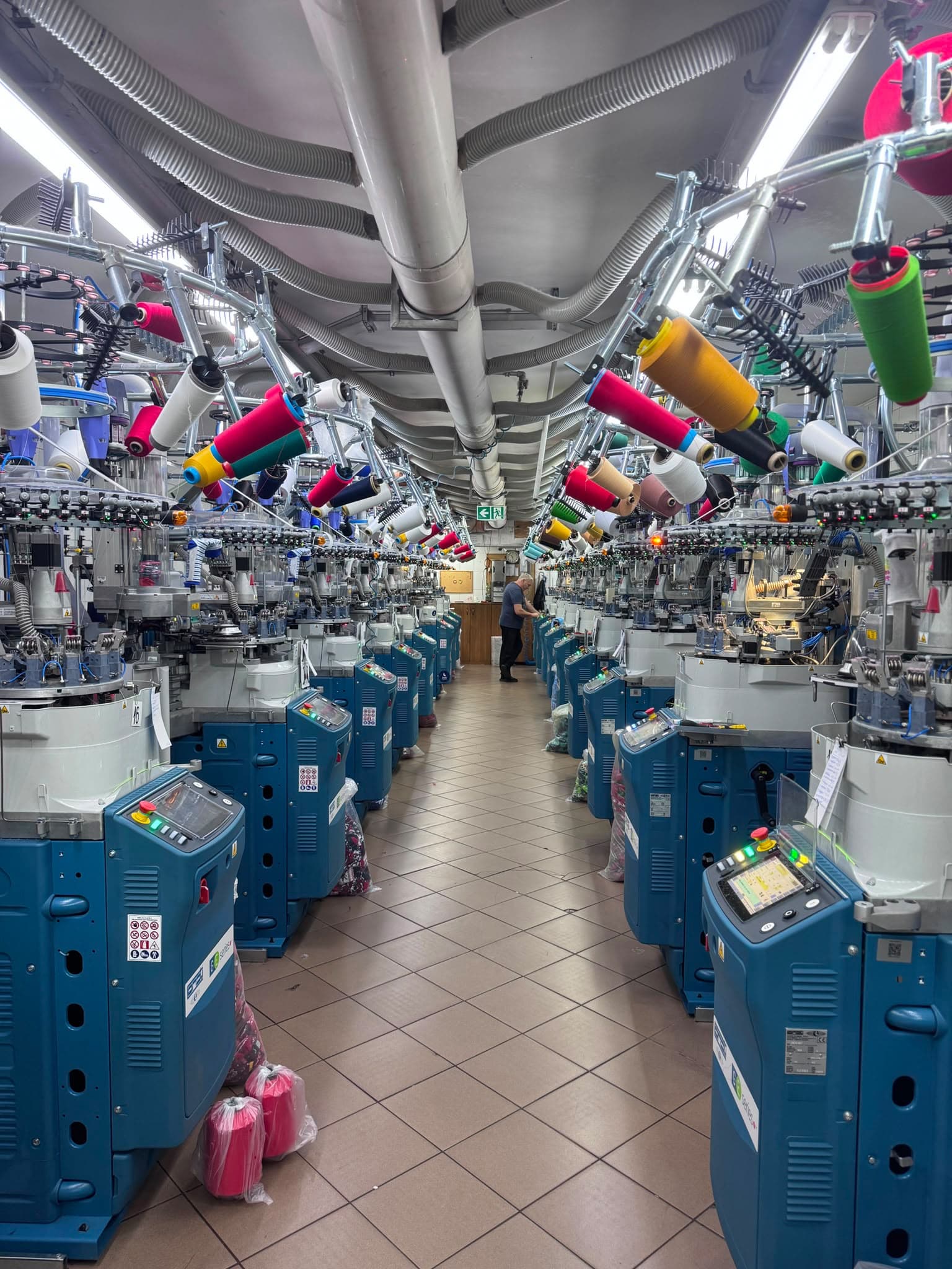 Laboratorio di produzione calze con macchine a maglia e filati colorati